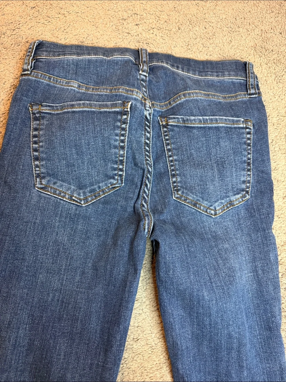 Free People indigo denim jeans with gold stitching